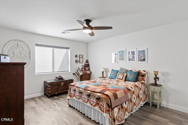 bedroom with hardwood / wood-style floors and ceiling fan