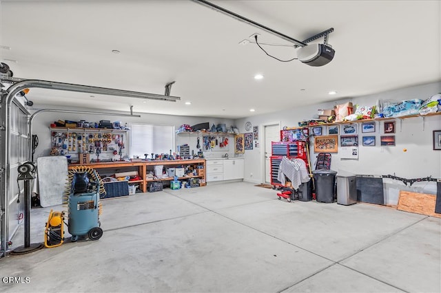 garage featuring a garage door opener and a workshop area