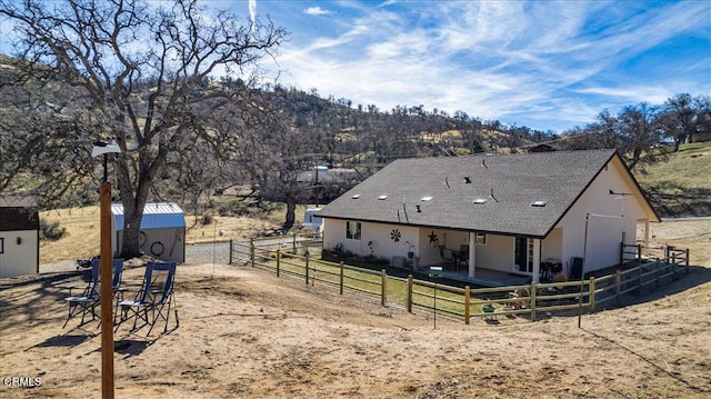 exterior space with a mountain view, a rural view, and a storage unit