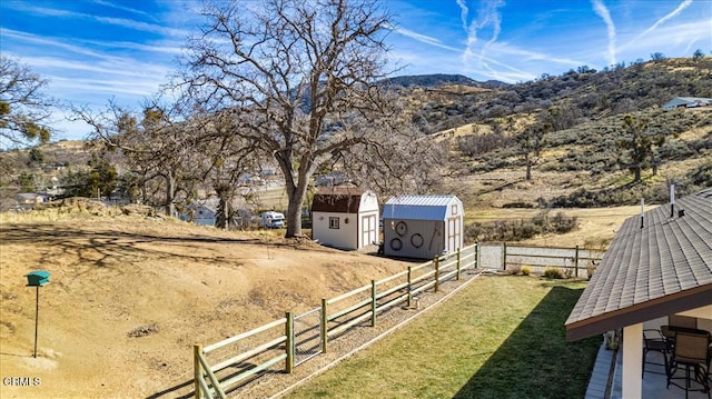 view of yard featuring a mountain view and a shed