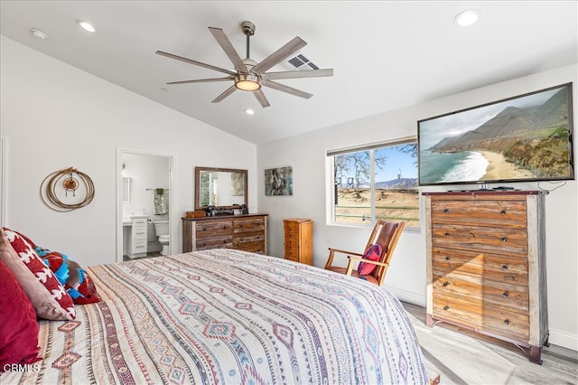 bedroom with vaulted ceiling, light hardwood / wood-style flooring, ceiling fan, and ensuite bath