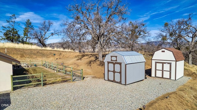 view of yard with a storage shed and a rural view