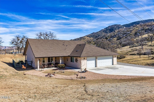 17600 Ascot Ct, Tehachapi, CA 93561 - view of front of property with a garage, concrete driveway, a shingled roof, a mountain view, and stucco siding