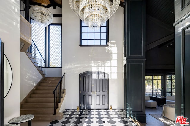 entryway featuring an inviting chandelier and a high ceiling