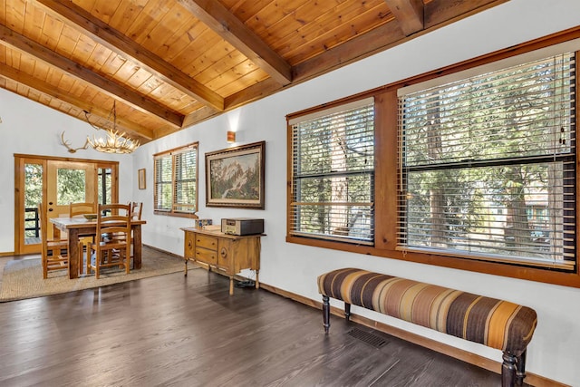 living area with dark hardwood / wood-style floors, vaulted ceiling with beams, a wealth of natural light, and wood ceiling