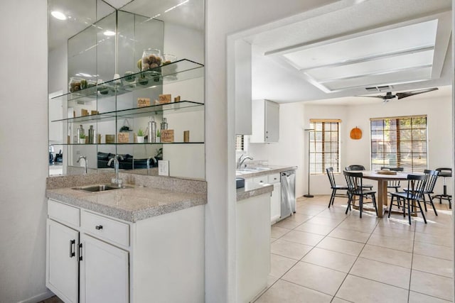 bar with white cabinetry, sink, stainless steel dishwasher, and light tile patterned flooring