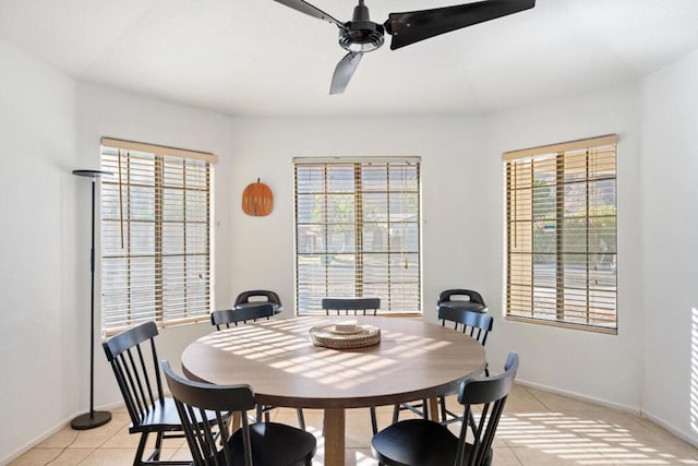 dining space featuring light tile patterned flooring, plenty of natural light, and ceiling fan