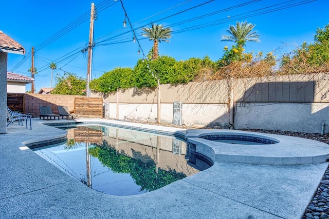 view of pool with an in ground hot tub