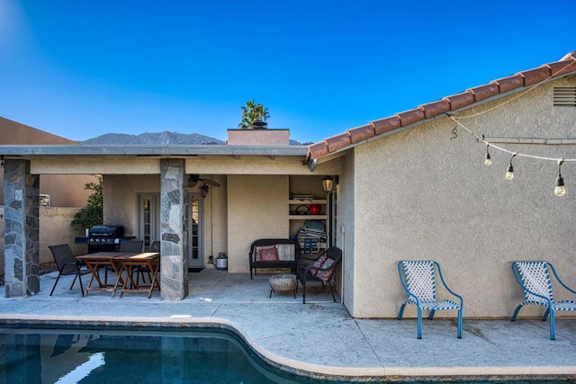 view of pool featuring a mountain view and a patio area