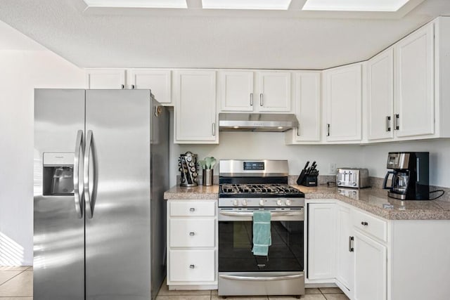 kitchen featuring white cabinetry, stainless steel appliances, and light tile patterned flooring