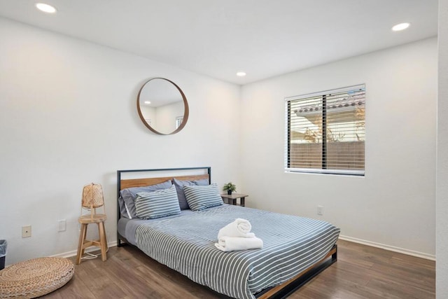 bedroom with dark wood-type flooring