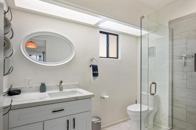 bathroom with vanity, tile patterned floors, toilet, and walk in shower