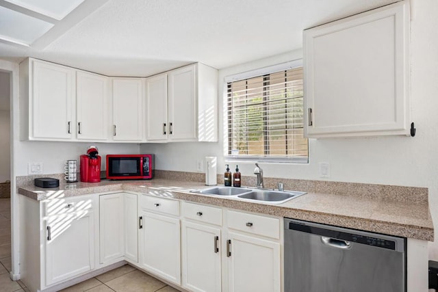 kitchen featuring white cabinetry, light tile patterned flooring, dishwasher, and sink