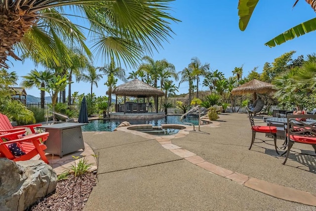 view of pool featuring a gazebo, an in ground hot tub, and a patio