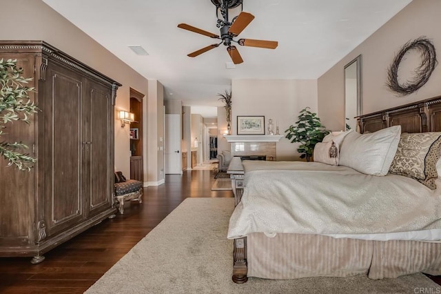 bedroom with dark hardwood / wood-style flooring and ceiling fan