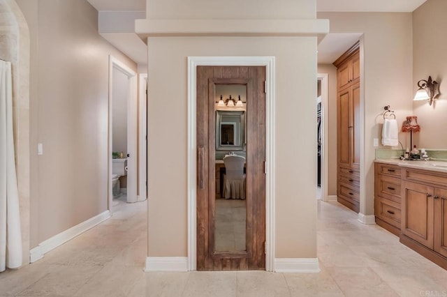 hall featuring light tile patterned flooring