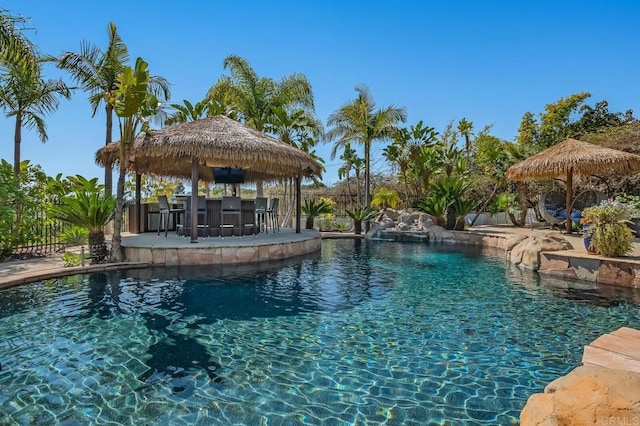 view of swimming pool featuring a gazebo and a bar