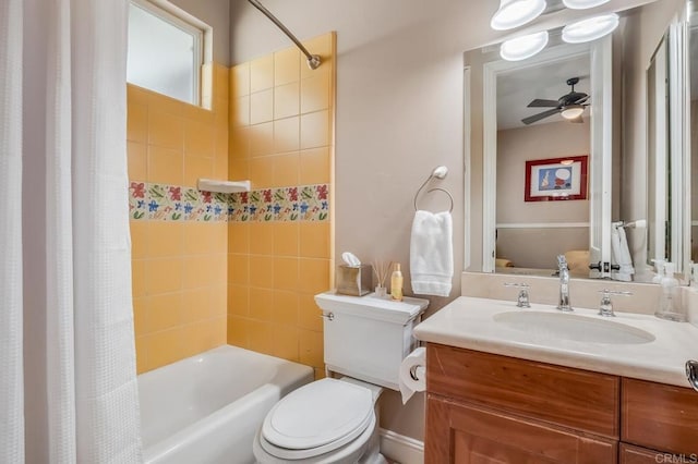 full bathroom with ceiling fan, shower / tub combo with curtain, vanity, and toilet