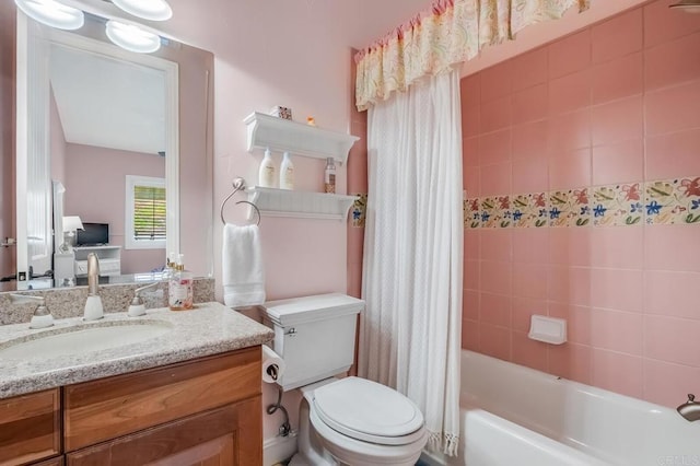 full bathroom with vanity, shower / bath combo, and toilet