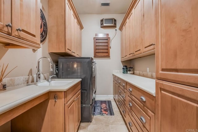 laundry area with cabinets and sink