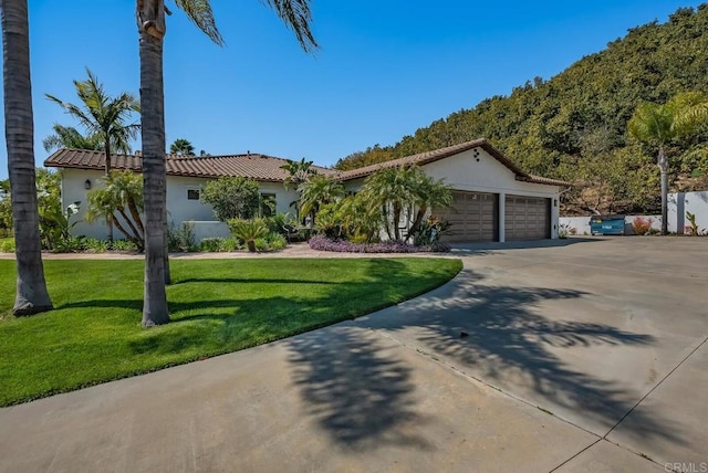 view of front of property featuring a garage and a front yard