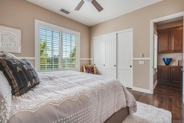 bedroom with dark hardwood / wood-style flooring, ceiling fan, and a closet