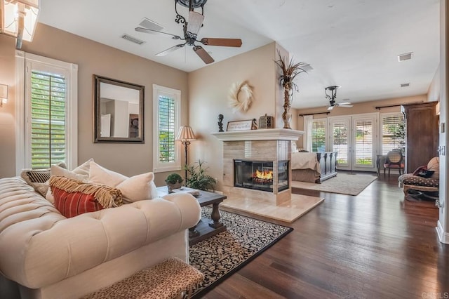 living room featuring french doors, ceiling fan, a premium fireplace, and dark hardwood / wood-style floors