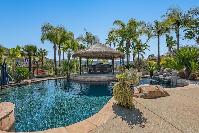 view of swimming pool with a gazebo, pool water feature, and a patio