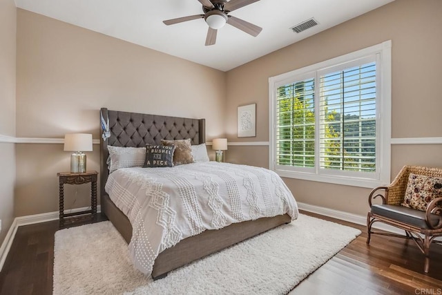 bedroom with dark hardwood / wood-style floors and ceiling fan