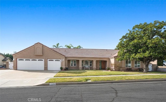 ranch-style house with a garage and a front yard