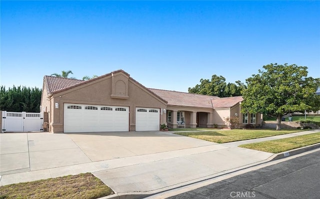 ranch-style house with a garage and a front lawn