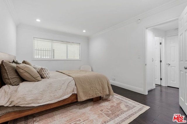 bedroom featuring crown molding and dark hardwood / wood-style flooring