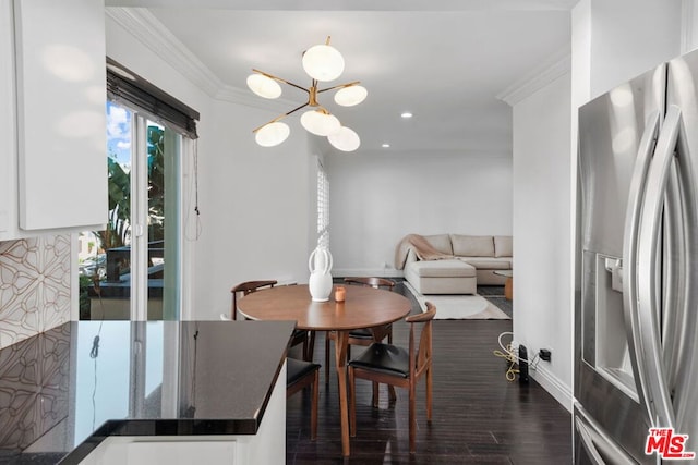 dining room with crown molding and dark hardwood / wood-style flooring