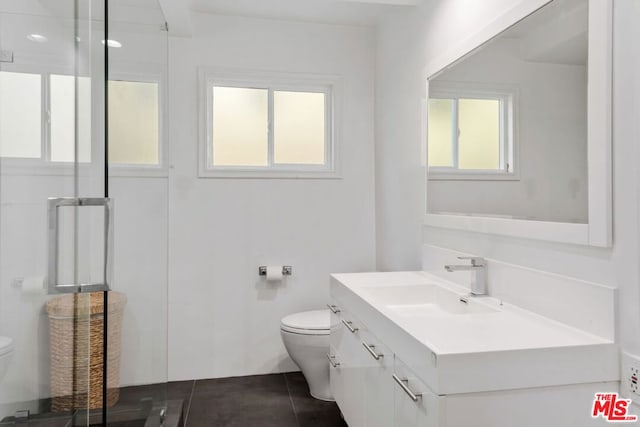 bathroom with vanity, toilet, and tile patterned flooring