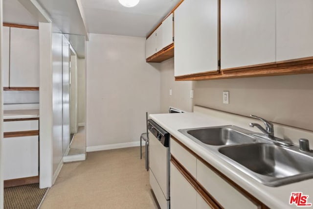 kitchen featuring dishwasher, sink, and white cabinets