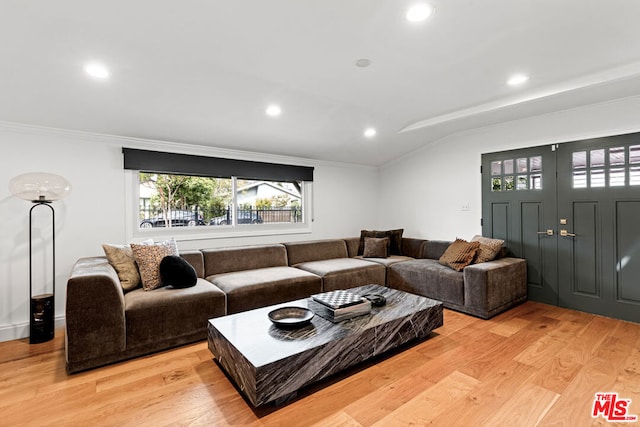 living room featuring light hardwood / wood-style flooring and ornamental molding