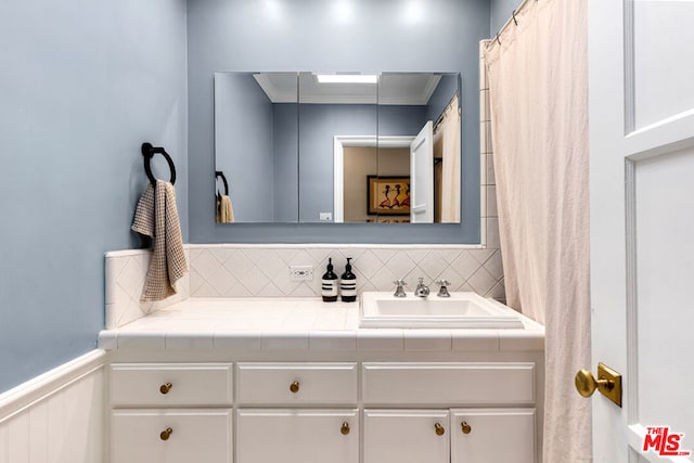 bathroom with vanity and ornamental molding