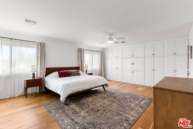 bedroom featuring multiple windows, ceiling fan, and light hardwood / wood-style floors