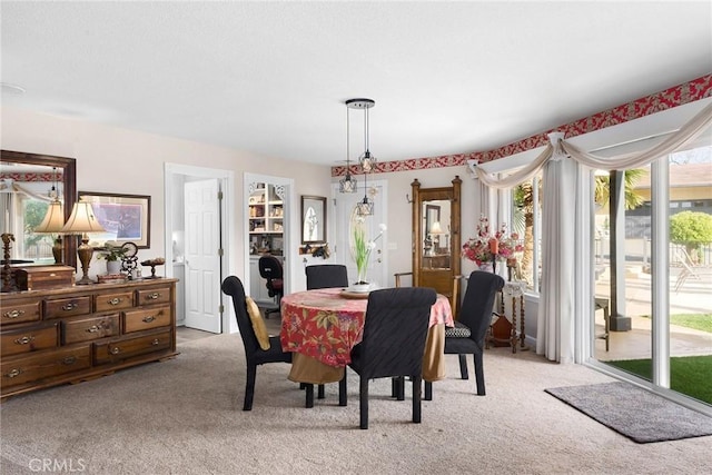 dining space with a healthy amount of sunlight and light colored carpet