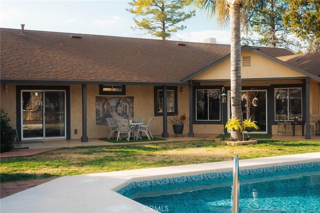 rear view of property with a yard