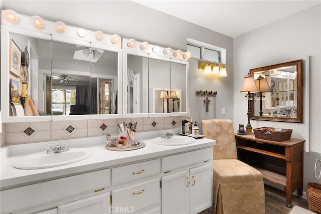 bathroom with vanity, ceiling fan, and decorative backsplash