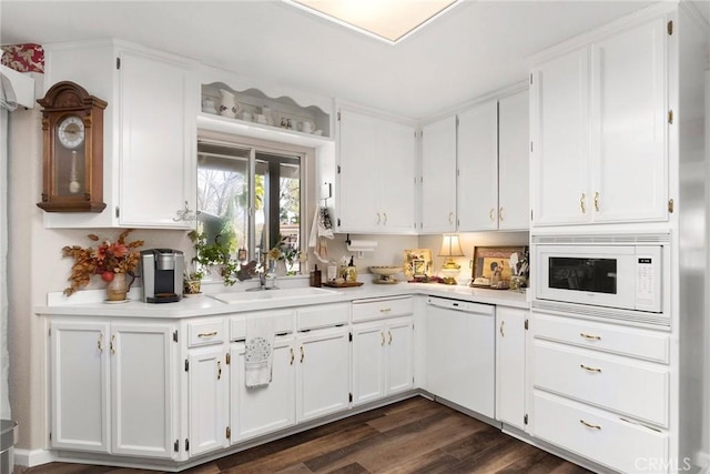 kitchen featuring dark wood-type flooring, white appliances, sink, and white cabinets