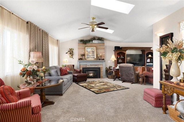 living room with ceiling fan, light colored carpet, and lofted ceiling with skylight