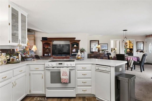 kitchen with dark colored carpet, white cabinetry, decorative light fixtures, electric range, and kitchen peninsula