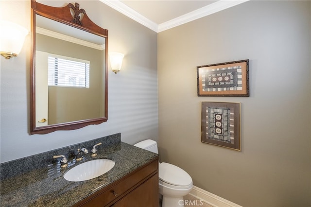 bathroom with crown molding, vanity, and toilet