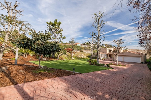 view of front of house with a garage and a front lawn