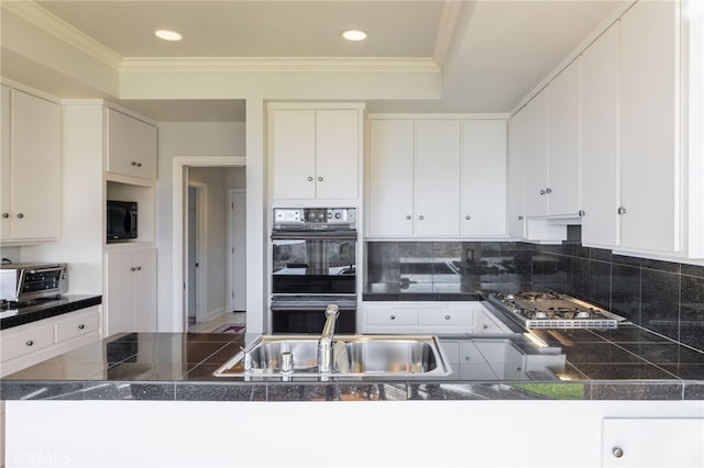 kitchen with sink, white cabinetry, crown molding, decorative backsplash, and black appliances