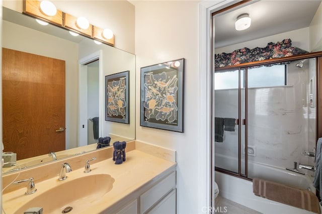 full bathroom featuring enclosed tub / shower combo, vanity, toilet, and tile patterned flooring