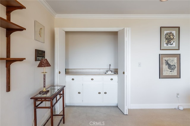 hallway with light carpet, sink, and ornamental molding