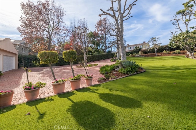 surrounding community featuring a garage and a lawn